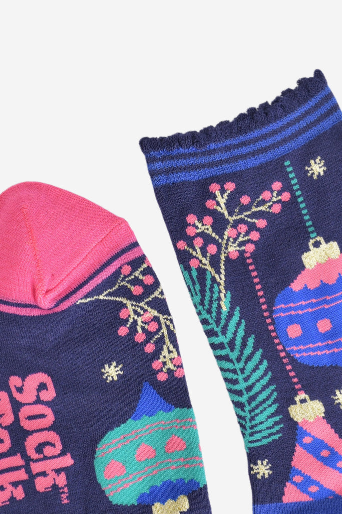 close up of the toe and cuff, the toe is pink, the cuff is scalloped with blue stripes