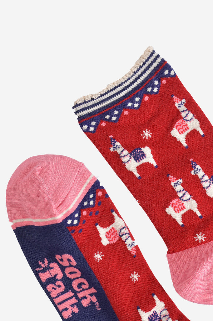 close up of the pink toe and white and navy scalloped striped cuff on the red llama socks