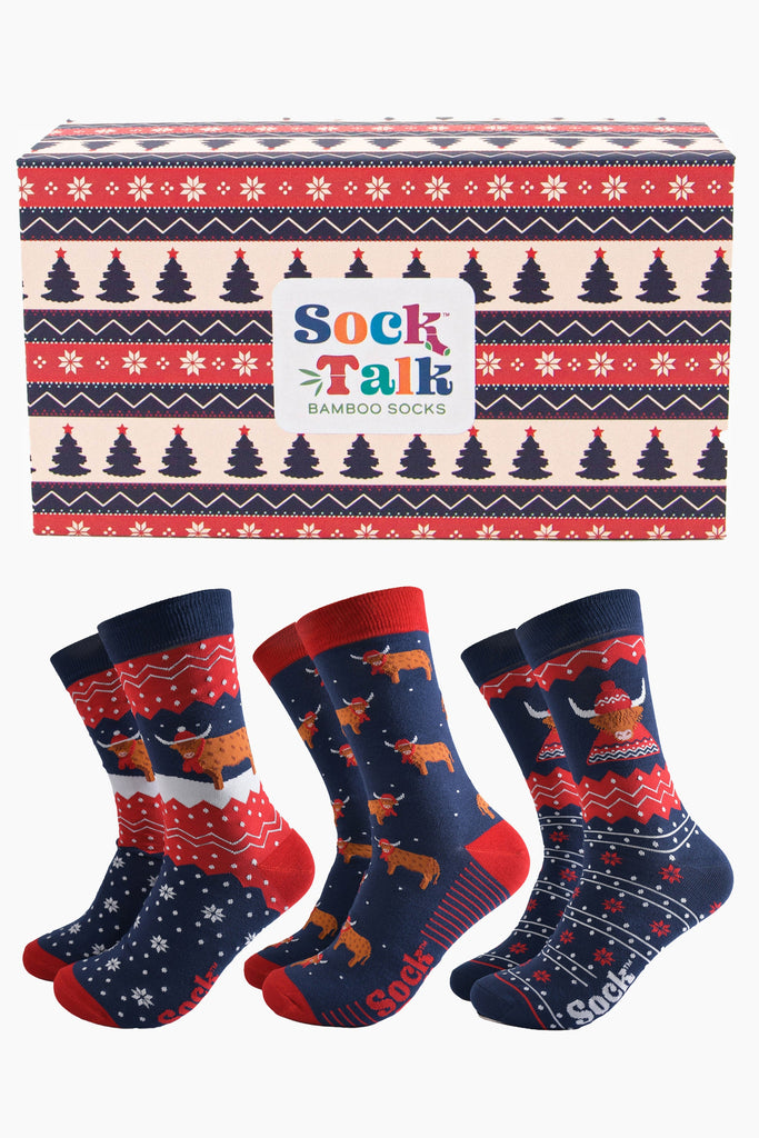 red, blue and cream fair isle style sock gift box with three pairs of festive themed highland cow socks 