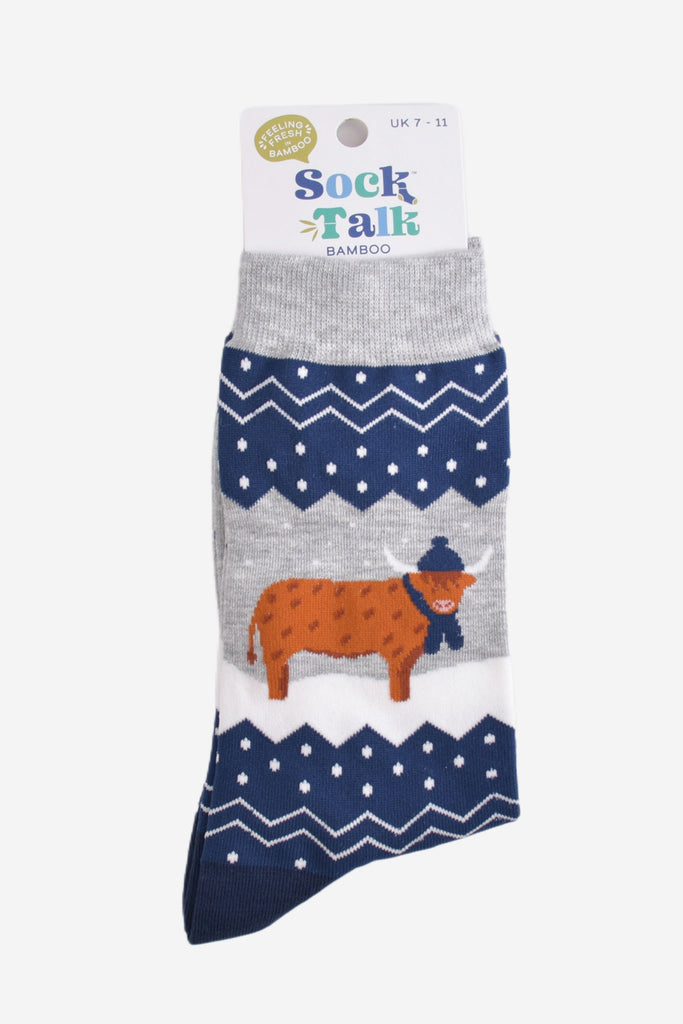 blue and grey fair isle highland cow socks in their sock talk packaging, these socks are a uk size 7-11