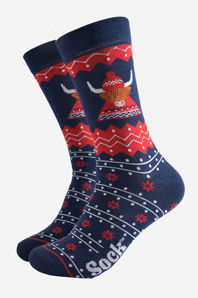 navy blue and red fair isle socks featuring a highland cow wearing a traditional knitted fair isle hat and jumper