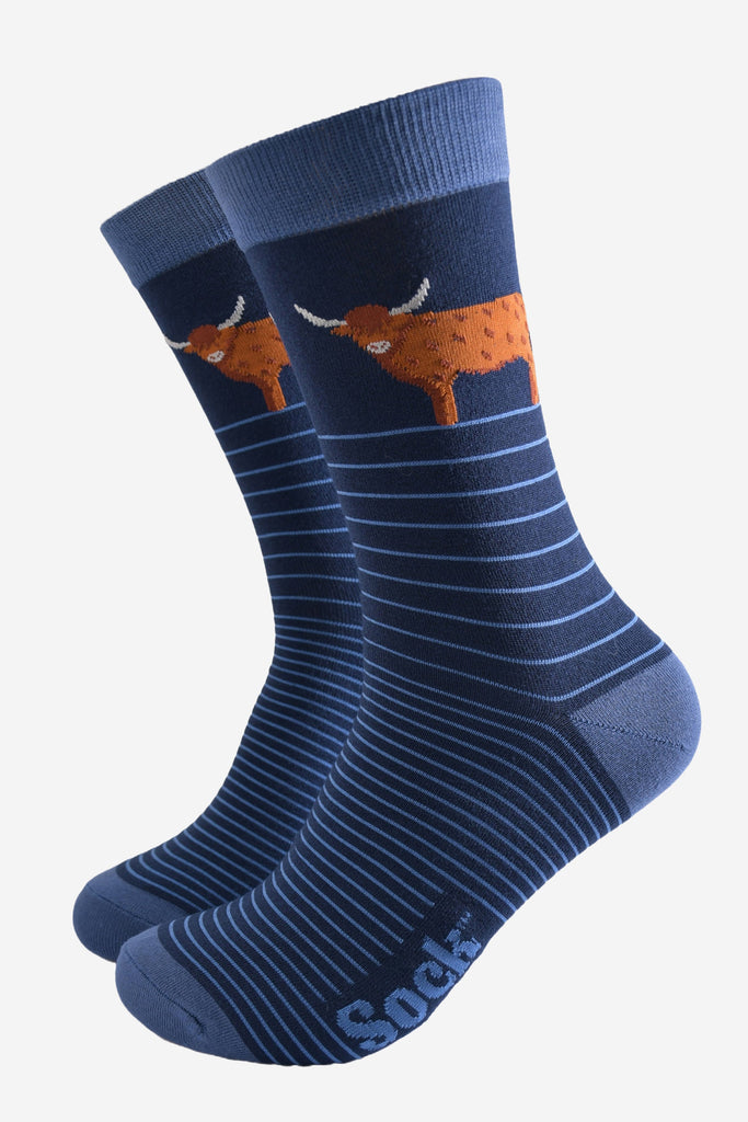 navy blue socks with light blue pin striped and a large standing highland cow on the ankle