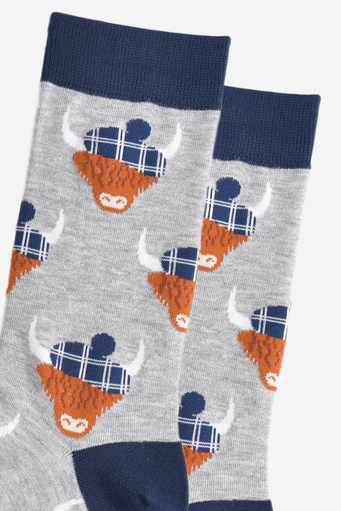 close up of the highland cow pattern, showing clearly the blue tartan hats they are wearing