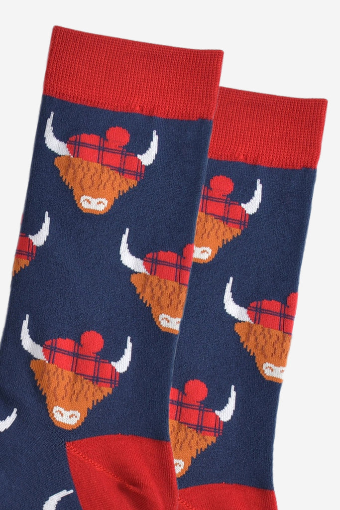 close up of the highland cow pattern, showing clearly the red tartan hats they are wearing