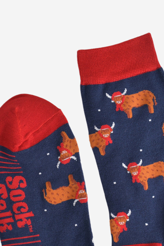 showing the toe and cuff of the highland cow socks, showing the stripe detail on the sole and a close up of the highland cow pattern
