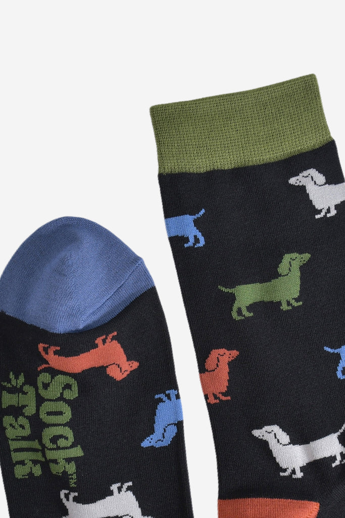 showing the toe and cuff of the socks, the cuff is green and the toe is blue