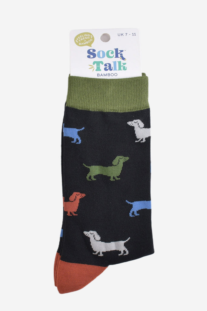 multicoloured sausage dog socks in their sock talk packaging, the socks are a uk size 7-11