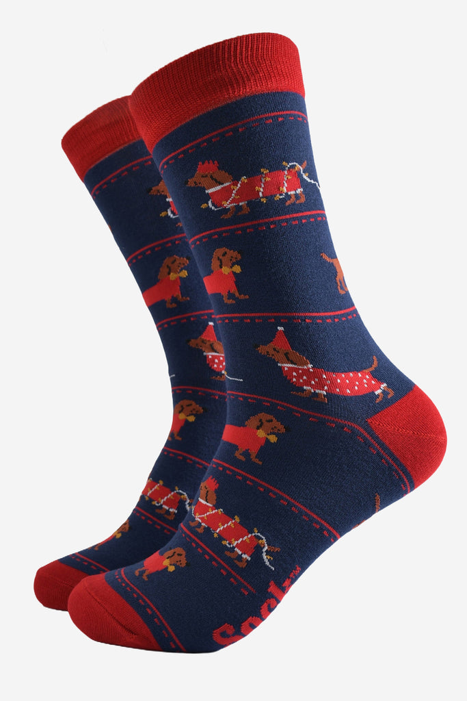 navy blue socks with a pattern on sausage dogs playing with party lights and wearing party hats