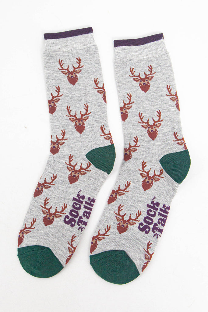 showing the socks laying flat, the stags head pattern is all over the socks