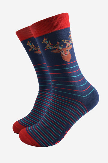 navy blue socks with a red cuff and toe with a red and green horizontal striped pattern with a stags head on the ankle, the stag is draped with colourful party lights