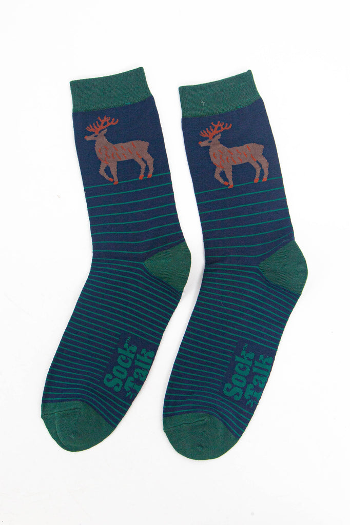 showing the navy and green striped stag socks laying flat, showing the stripe pattern and large stag standing in profile on the ankle of the socks