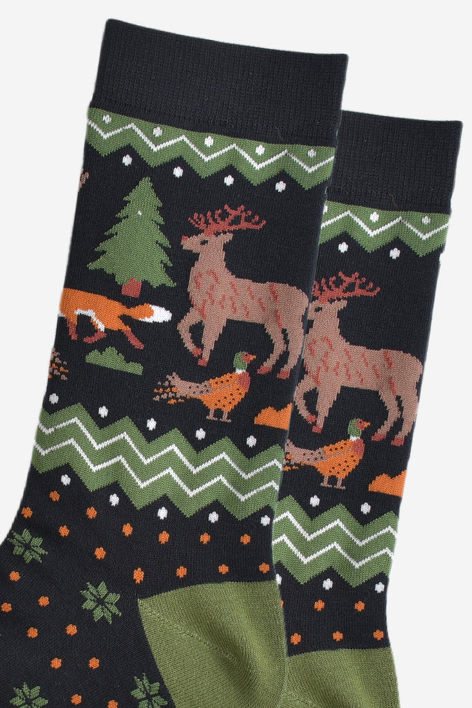 close up of the woodland animals on the ankle of the socks, there is a pheasant, red fox and stag with antlers