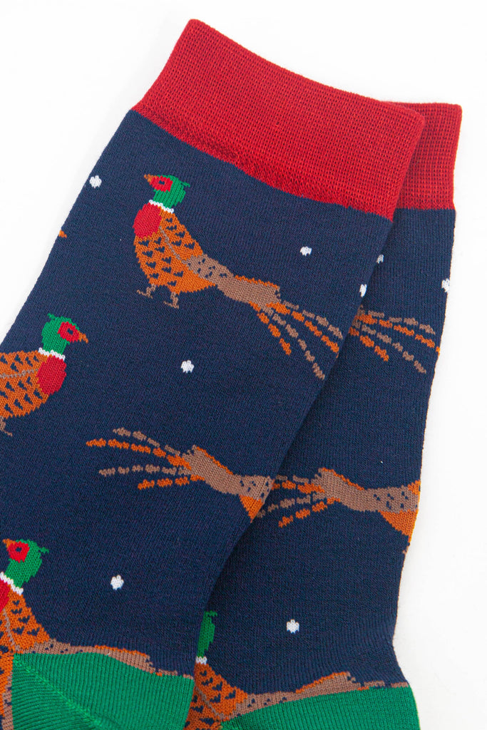 close up of the woodland pheasant design, the pheasants are orange and brown with red bellies and green and red heads. 
