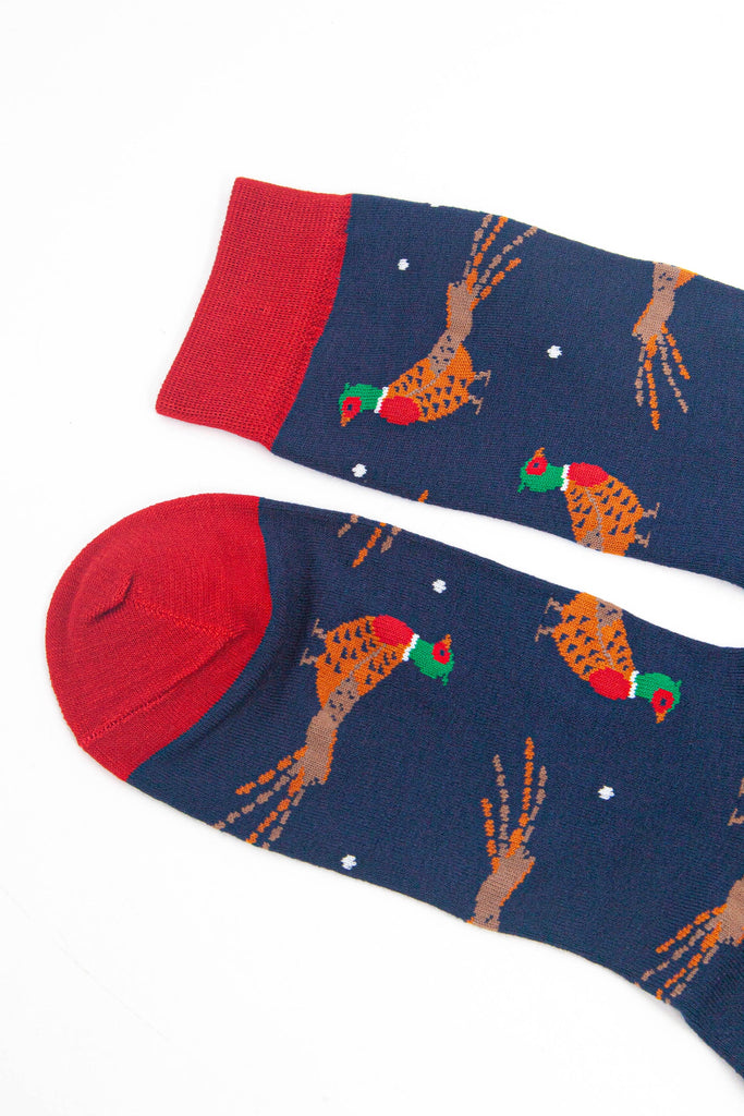 close up of the toe and cuff, both are red and contrast the navy blue base of the socks and complement the red accents on the pheasants