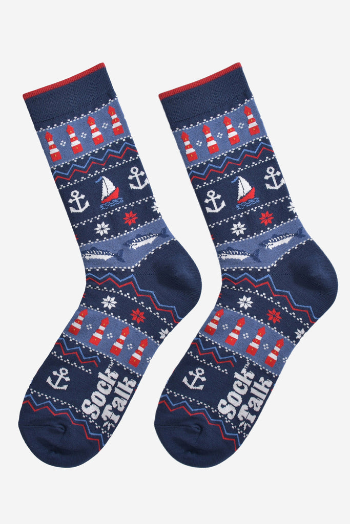 navy blue nautical fair isle socks laying flat, showing the intricate design which includes fish, anchors, boats and lighthouses