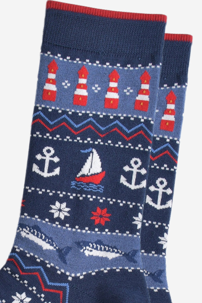 close up of the nautical designs on the socks, the lighthouses, boats, anchors and fish are shown