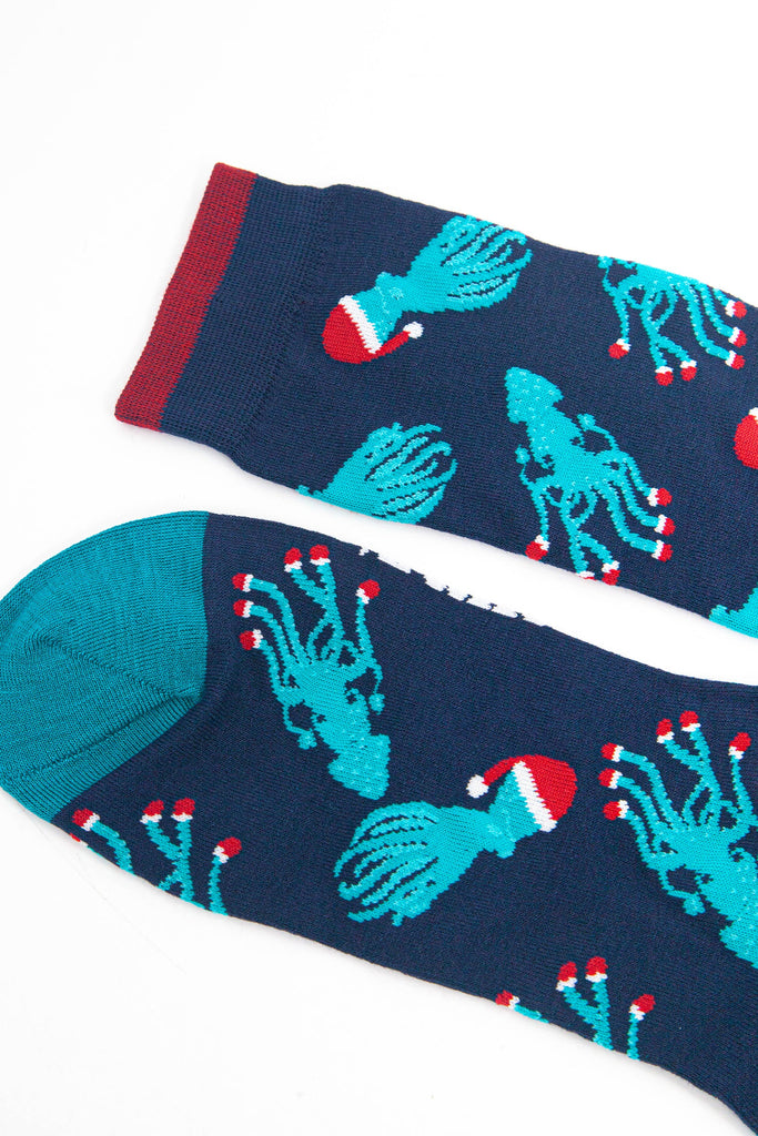 close up of the toe and cuff, the toe is teal blue, the cuff has burgundy red stripe on the edge