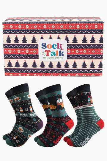 fair isle style gift box in red, blue and cream featuring snowflakes, and xmas trees with three pairs of festive treat themed bamboo socks