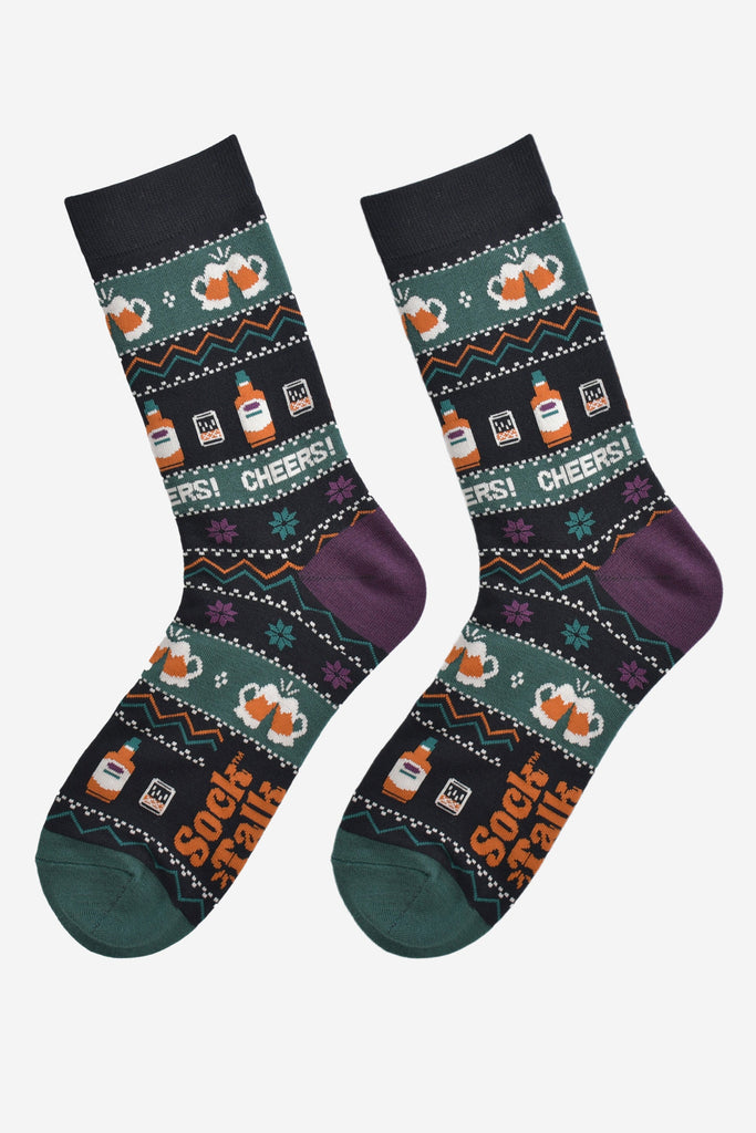 fair isle party drinks socks laying flat, showing the detailed pattern which has whisky glasses, beer mugs and the word cheers running through the design