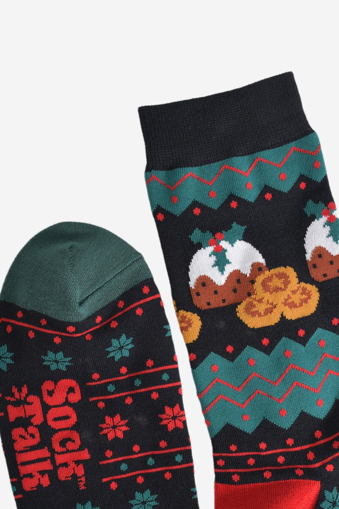 close up of the cuff and toe of the socks, the cuff is black and the toe is green, the fair isle pattern is shown clearly