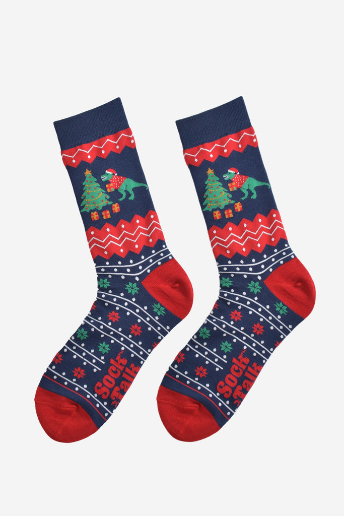 navy blue and red fair isle pattern socks laying flat, showing clearly the detail of the pattern and t-rex xmas tree design on the ankle of the socks