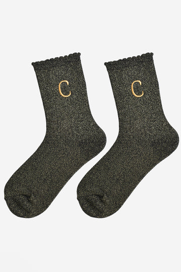 showing the glitter socks laying flat, they have a scalloped cuff and an all over gold sparkle