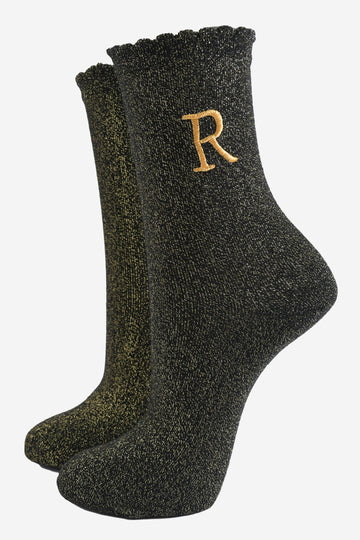 black ankle socks with a scalloped cuff, with an all over gold glitter sparkle and an embroidered gold letter r on the ankle