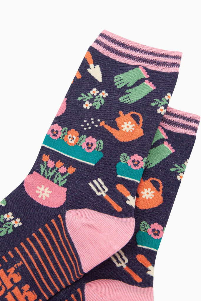 womens-bamboo-socks-navy-gardening-close-up-of-the-design-showing-wateringcans-gloves-tools-and-flower-pots