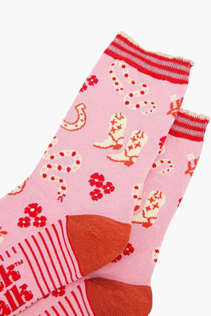 womens-bamboo-socks-pink-western-cowgirl-snakes-close-up-white-cowboy-boots-winding-rattle-snakes-red-desert-flowers-all-on-pink-background
