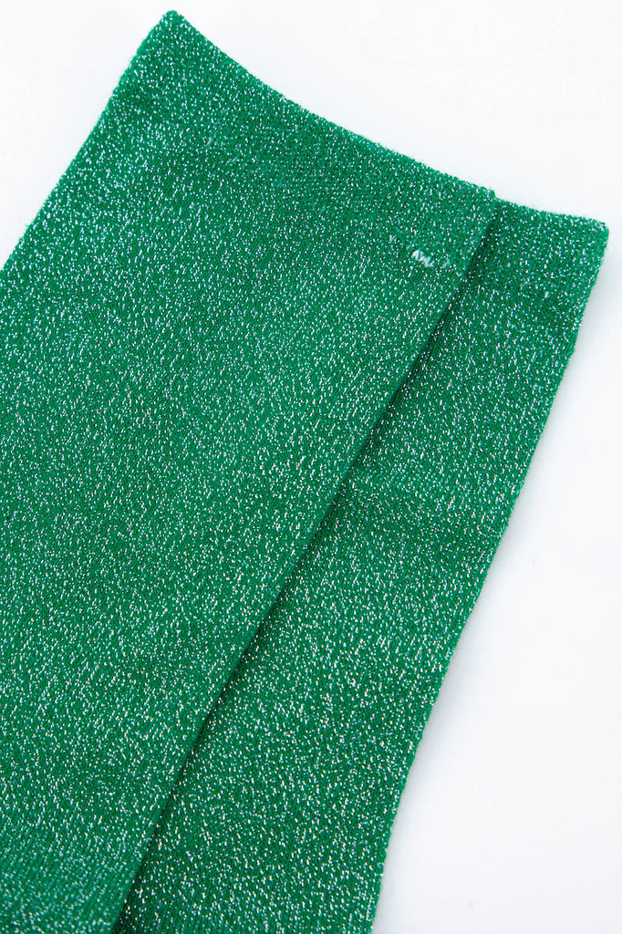 close up of the silver glitter sparkle on the green glitter socks