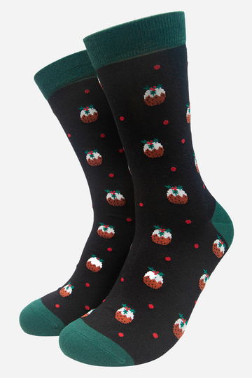 black socks with green heel, toe and cuff with an all over pattern of christmas puddings