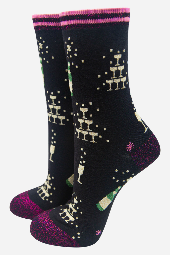 black bamboo socks with gold glitter champagne glasses and bottles, the socks have a pink glitter heel, toe and cuff