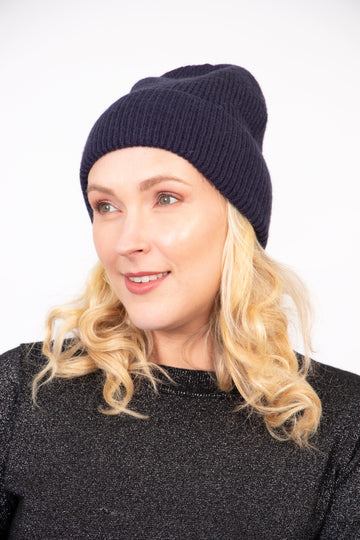 model wearing a navy blue winter beanie hat