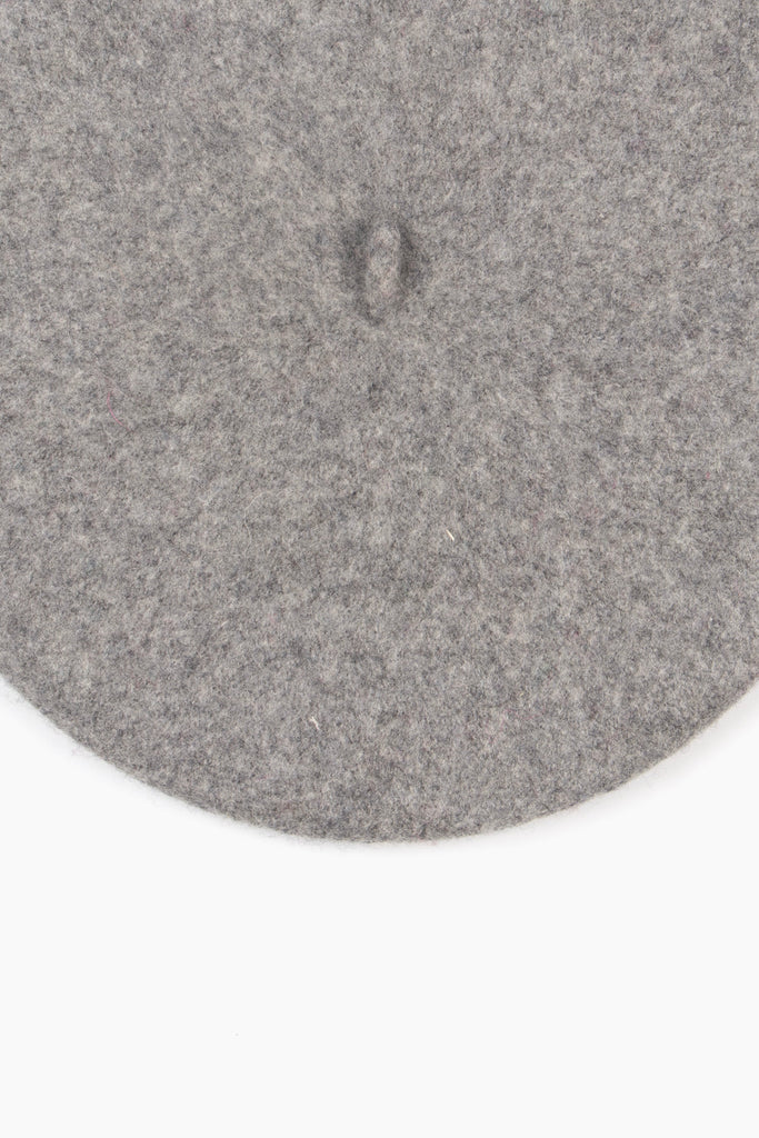 close up of the plain light grey beret, showing the textured wool blend fabric