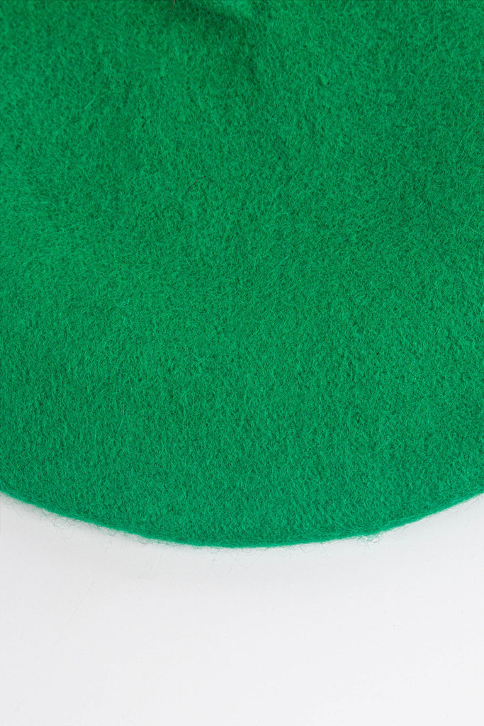 close up of the plain green beret, showing the textured wool blend fabric