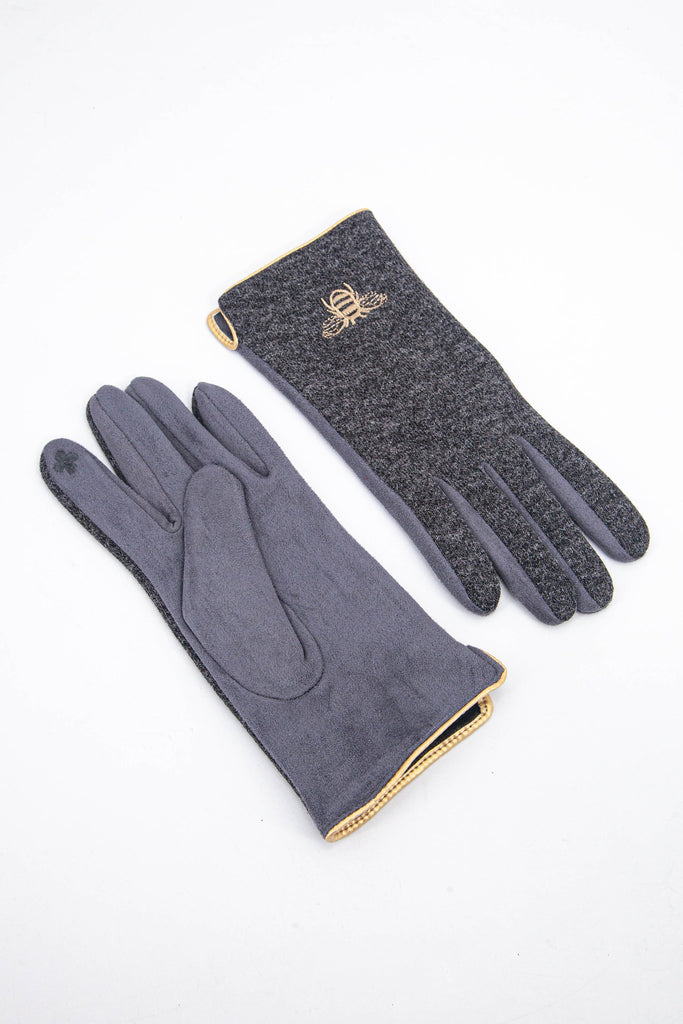 grey winter gloves with a touch screen sensitive index finger, gold trim around the wrist and a gold embroidered bee on the back of the wrist.