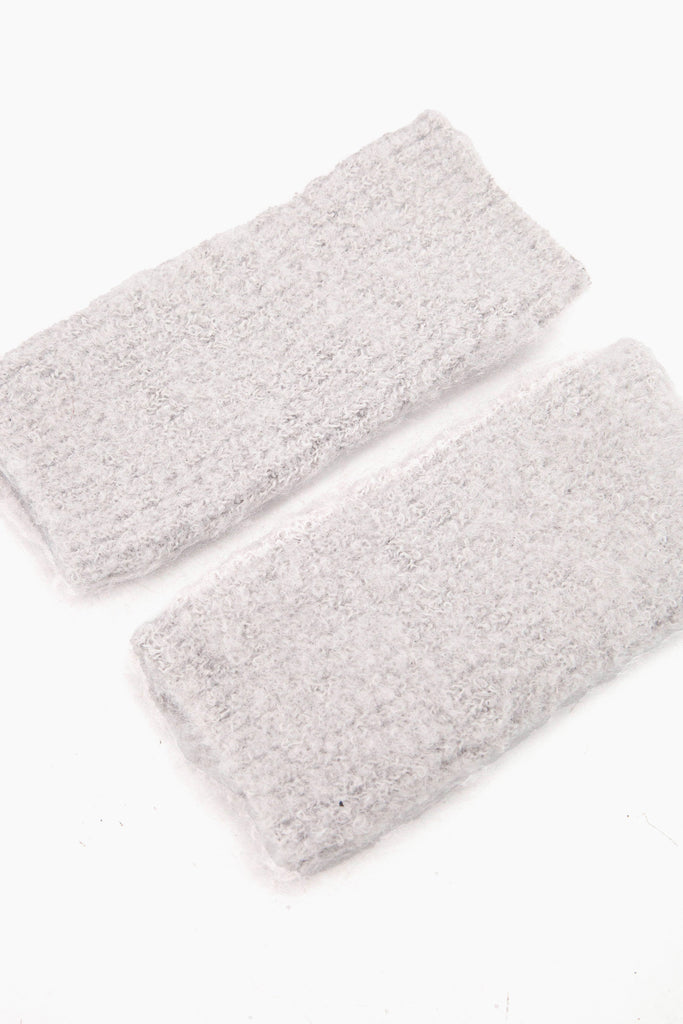 side view of the knitted wrist warmers, showing the opening at each end