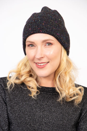 model wearing a light black marl knit beanie hat