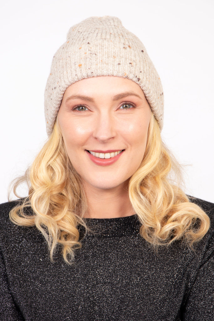 model wearing a cream marl knit beanie hat