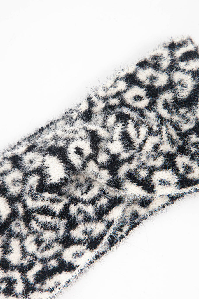 close up of the fluffy material of the black and white animal print headband