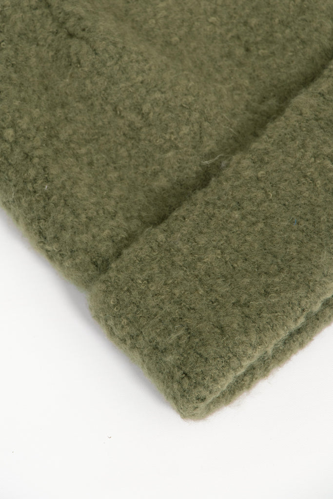 close up of the fluffy textured knitted fabric of the beanie hat.