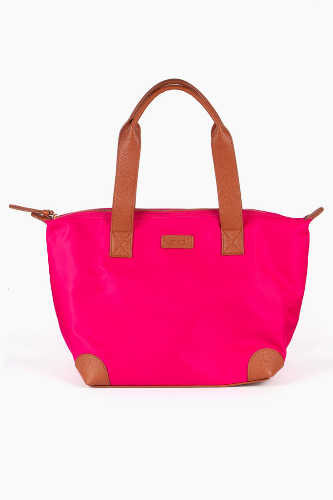 hot pink tote bag with brown tan accents and a brown carry handle, the bag has an external zip closure fastening on the top