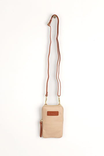 cream crossbody phone bag with tan accents and a tan removable adjustable crossbody strap