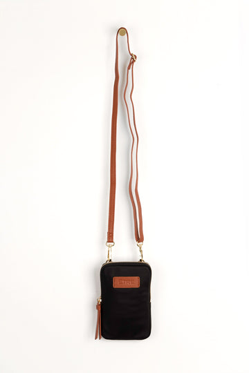 black crossbody phone bag with tan accents and a tan removable adjustable crossbody strap