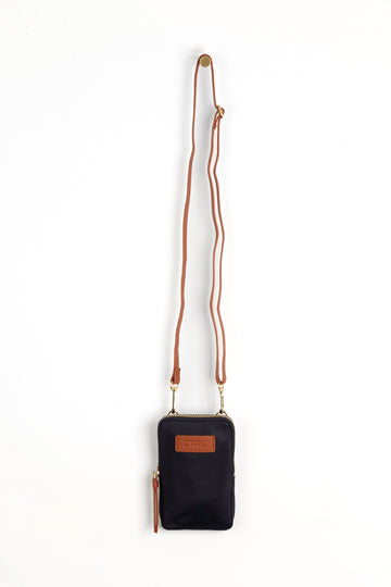 navy blue crossbody phone bag with tan accents and a tan removable adjustable crossbody strap