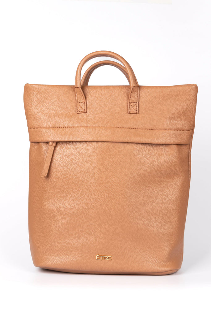 plain tan back pack with top handles and a zip closure, the bag is made from faux leather PU