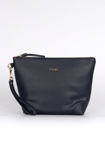 navy blue faux leather vanity bag with a detachable wrist strap and top zip closure