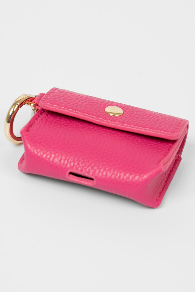 asher-wireless-earbuds-case-pink-faux-leather-laying-flat-charging-cut-out-showing