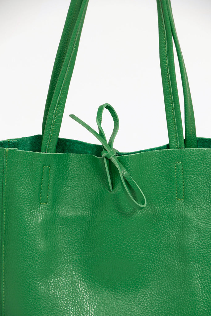 close up of the top tie fastening on the bright green leather tote bag
