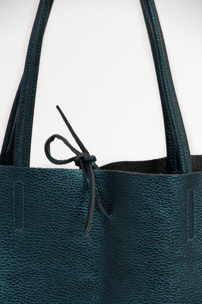 close up of the top tie fastening on the teal leather tote bag